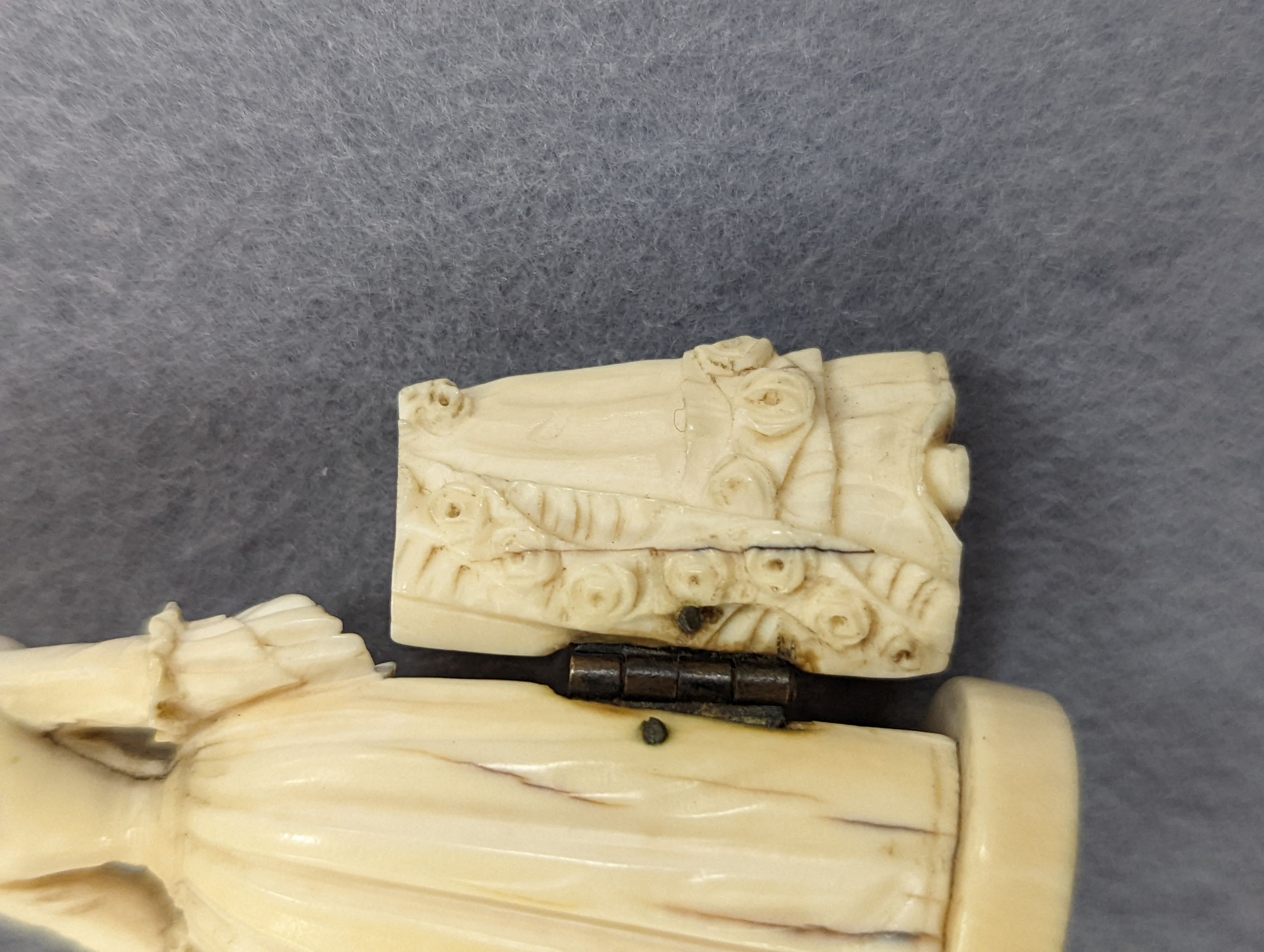 A pair of 19th century ivory balm pots, 3.75cm., a smallDieppe triptych figure, 6.5cm. a Meiji tiger brooch and a Dutch page marker.